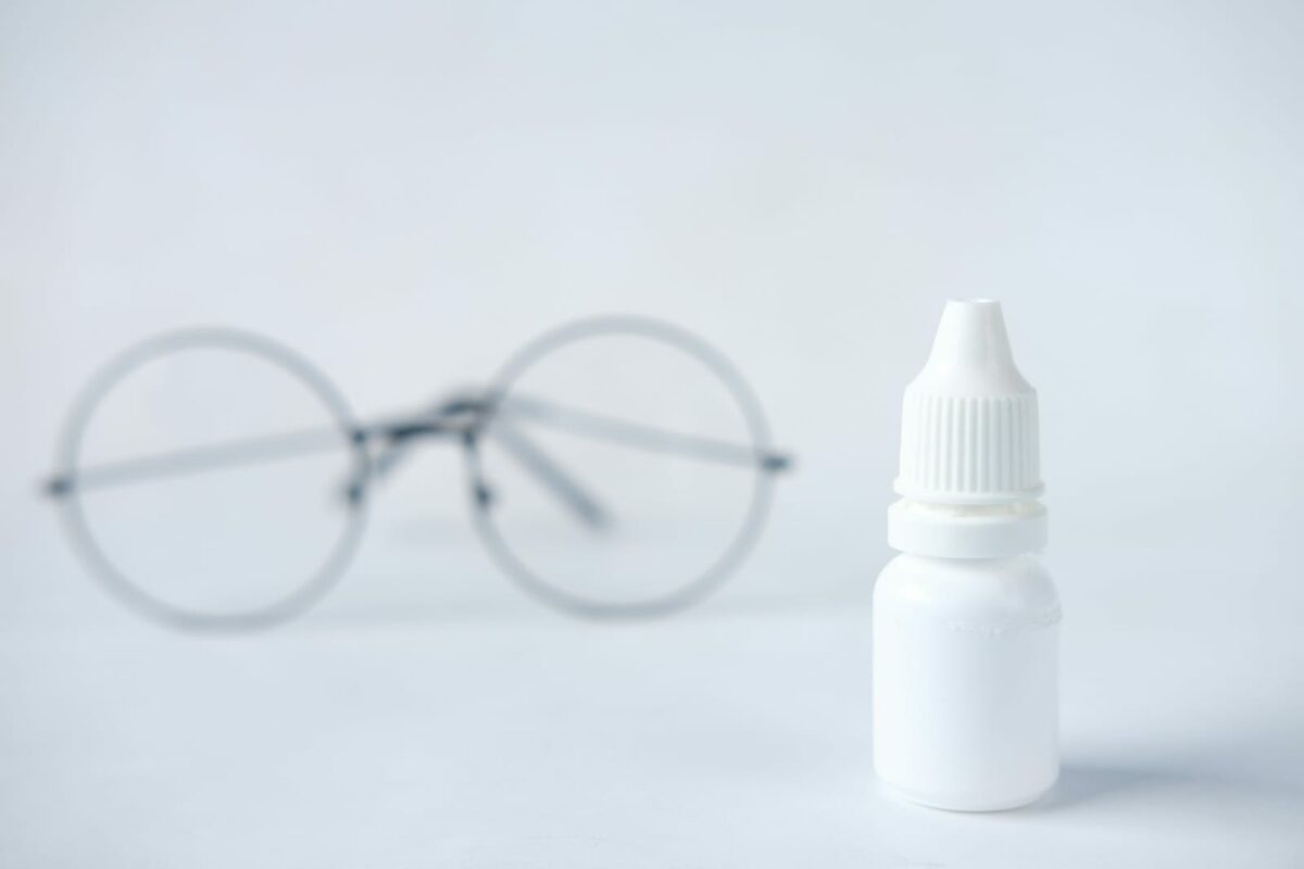 glasses and eyedrops next to each other