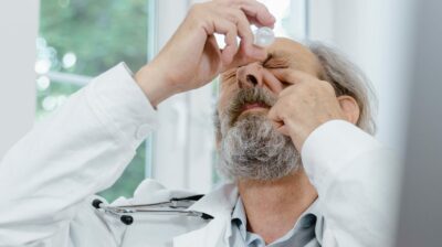 doctor using eyedrops